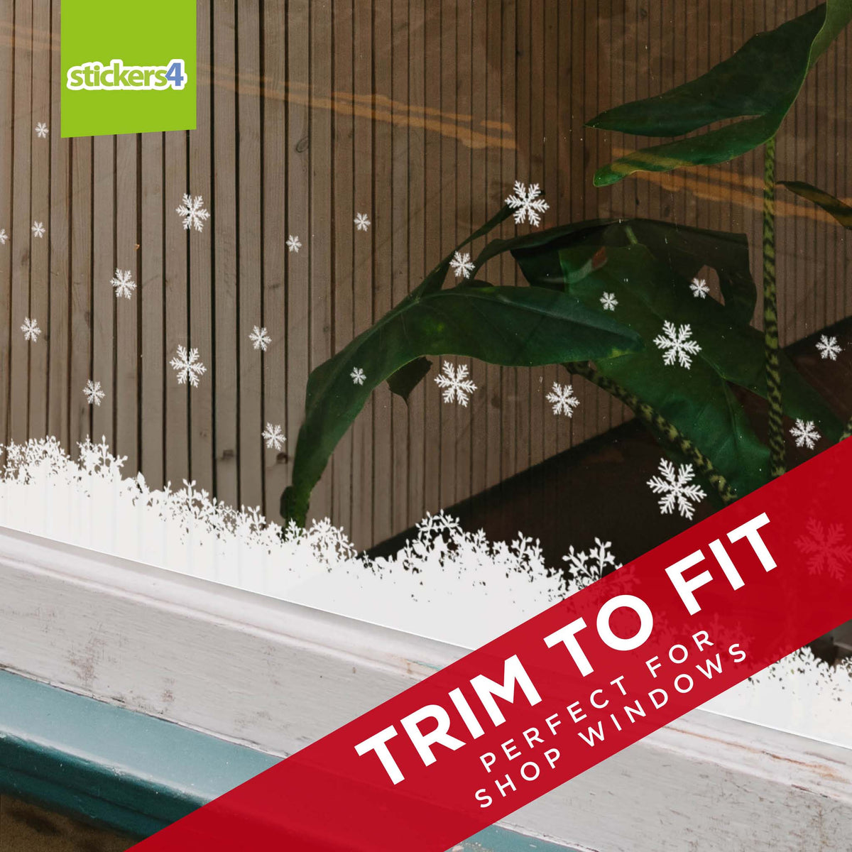 Decorative snowflake stickers on a window with 'stickers4' branding and text about fitting for shop windows.
