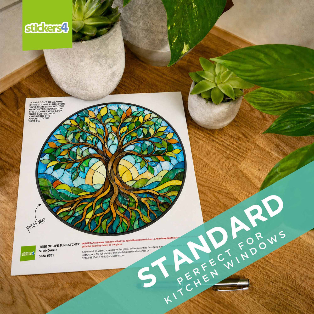 Colorful tree design on paper with potted plants on a wooden surface, featuring 'stickers4' branding.
