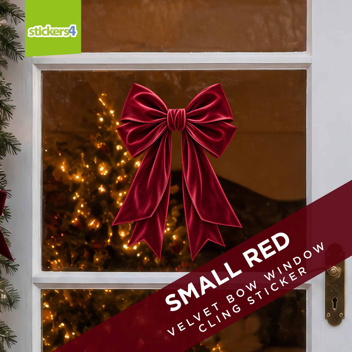 Small red velvet bow Christmas window sticker with festive lights behind
