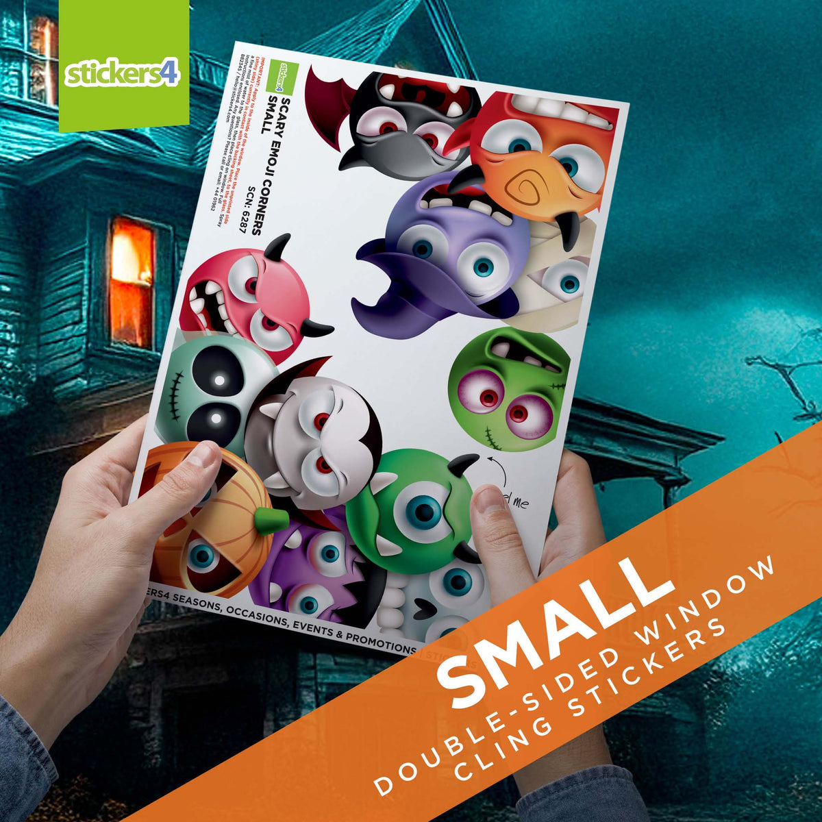 Sheet of small double-sided window cling stickers held by a person with a Halloween-themed background.